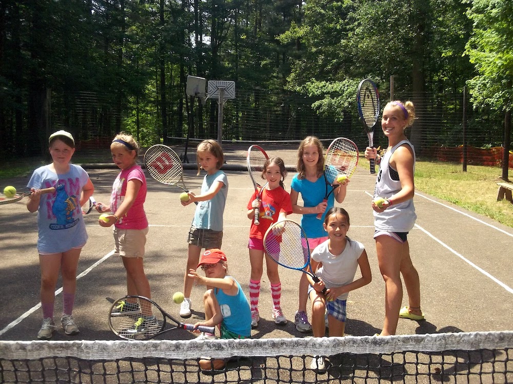 Girls learning tennis at summer camp